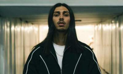 Baby Gang in posa frontale con capelli lunghi e tuta nera, foto promozionale per il singolo Problema