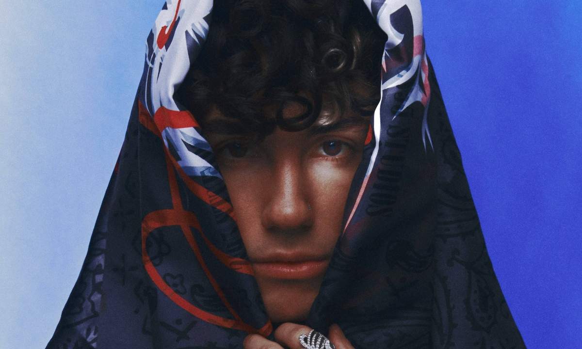 Niky Savage in primo piano con un foulard decorato sul capo, scatto promozionale del singolo Napoletana