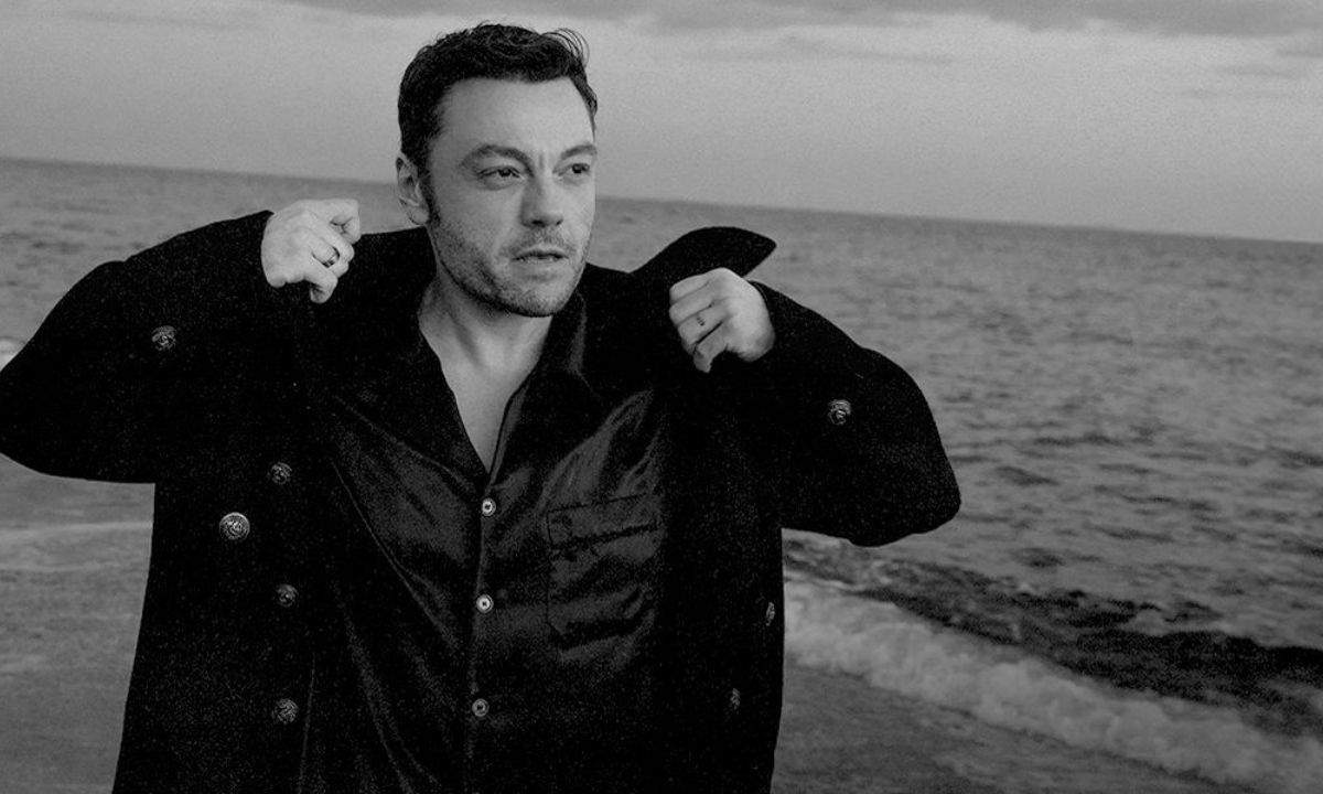 Tiziano Ferro in un ritratto in bianco e nero in riva al mare