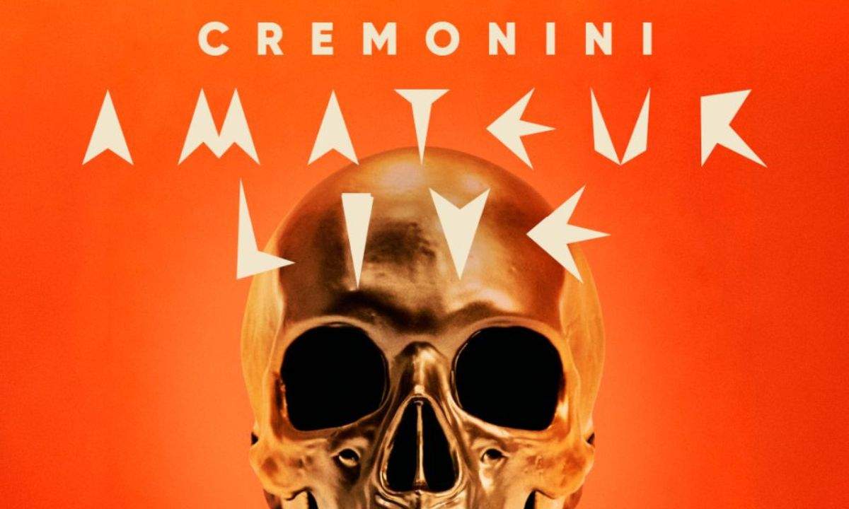 Locandina di Cremonini Amateur Live con teschio dorato su sfondo arancione, scritte bianche Cremonini Amateur Live
